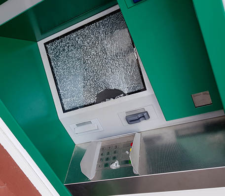 The attacker committed a robbery of an ATM smashing glass and showered fragments