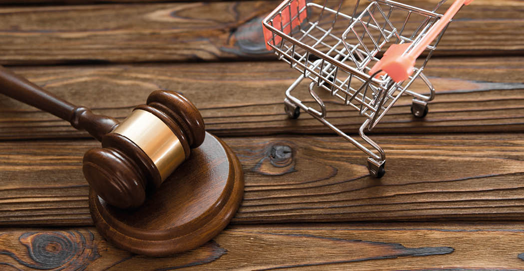 A wooden table with a shopping cart and a gavel on it. AI generated content