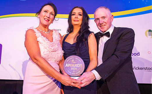 Three people are standing on a stage, holding an award. AI generated content