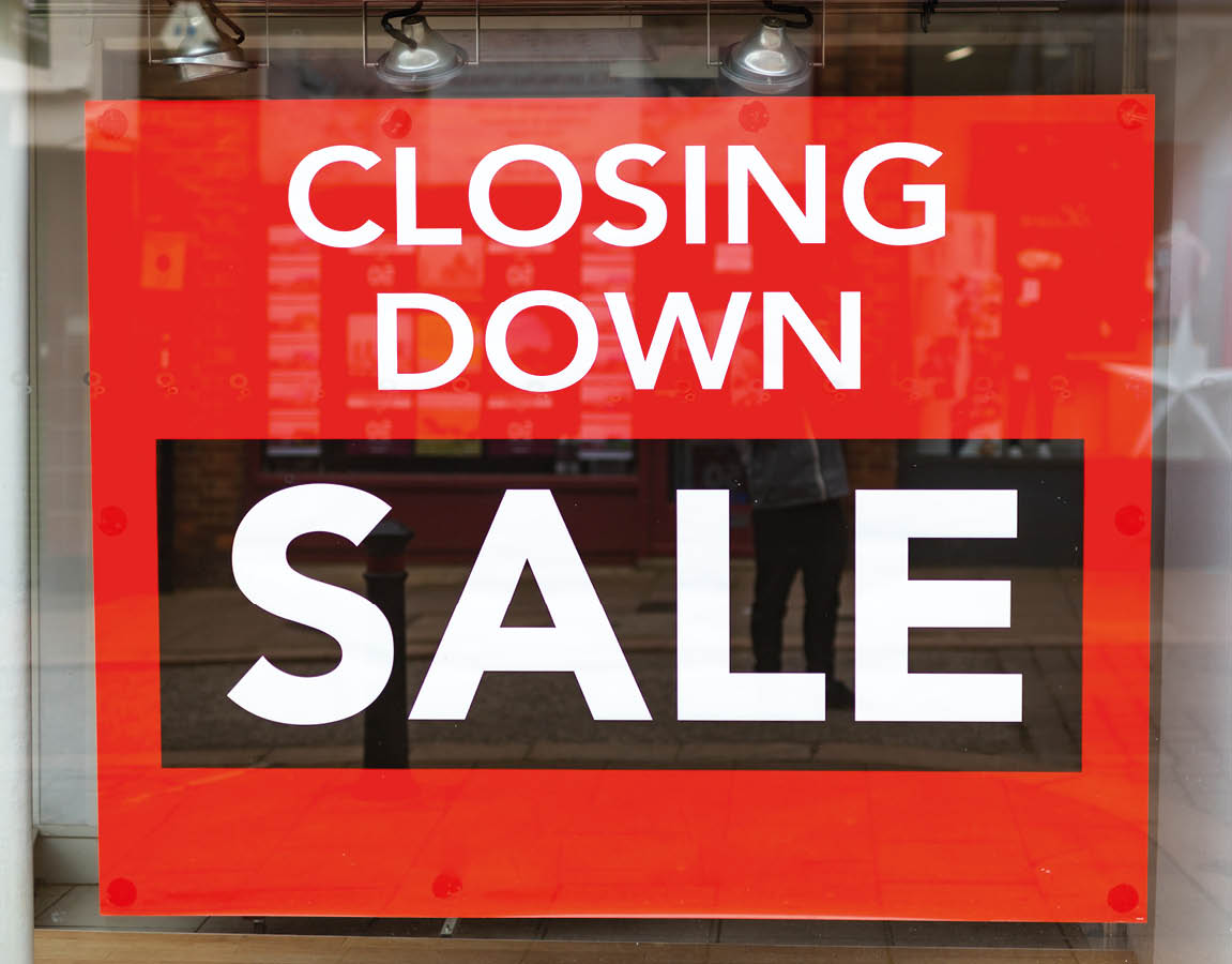 A window display with a red sign that says Closing Down Sale. AI generated content