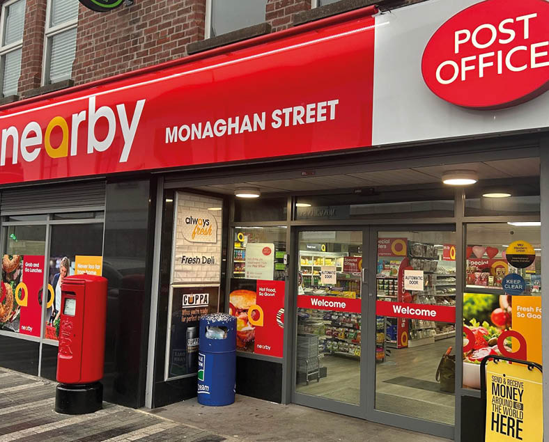 A post office with a red sign on the side of the building. AI generated content