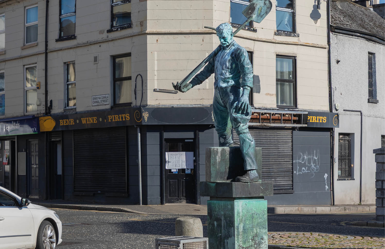 A statue of a man holding a baseball bat is located in front of a building. AI generated content