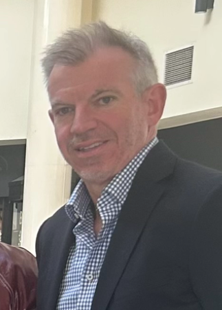 A man wearing a suit and tie poses for a picture. AI generated content