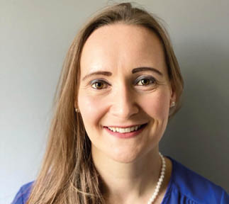 A woman wearing a blue shirt and pearl necklace is smiling. AI generated content