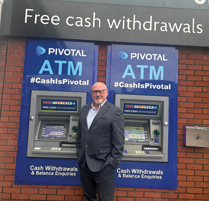 A man in a suit stands in front of two ATMs. AI generated content