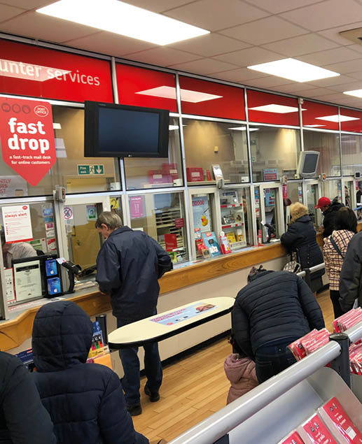 A group of people are waiting in line at a counter in a store. AI generated content