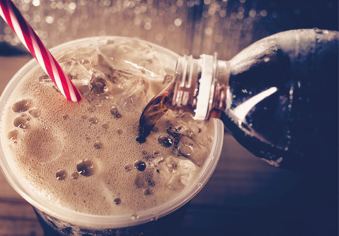 Refreshing Bubbly Soda Pop with Ice Cubes. Cold soda iced drink in a glasses - Selective focus, shallow DOF.
