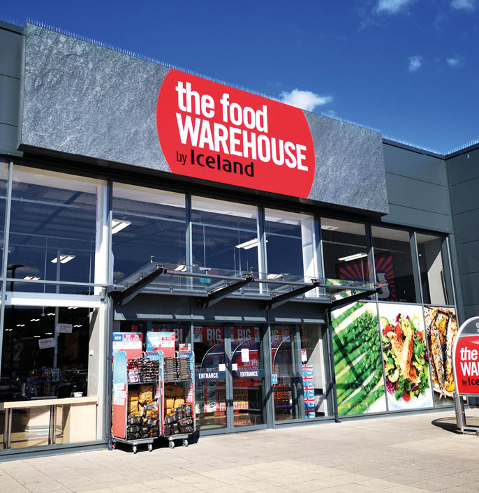 Swansea, UK: July 03, 2019: Exterior of The Food Warehouse by Iceland frozen food supermarket with merchandise on display.