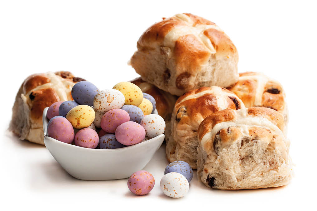 Easter chocolate eggs with cross buns isolated on white 