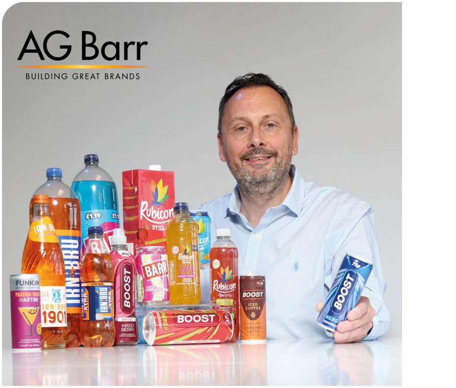 A man is standing in front of a table with a variety of drinks and snacks. Description generated by AI