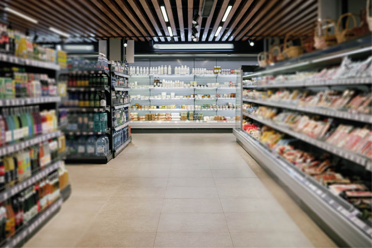 A grocery store with a tile floor and shelves of food. Description generated by AI