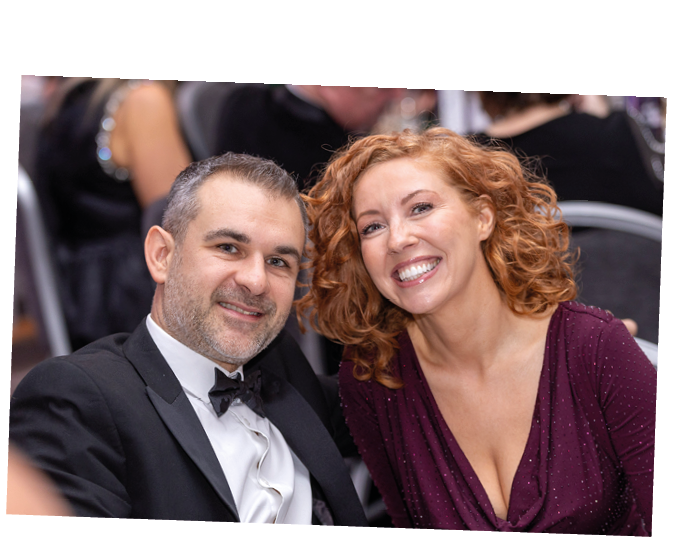 A man and woman are sitting together at a table. Description generated by AI