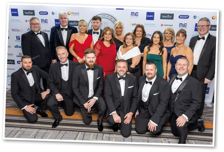 A group of people wearing tuxedos and bow ties. Description generated by AI