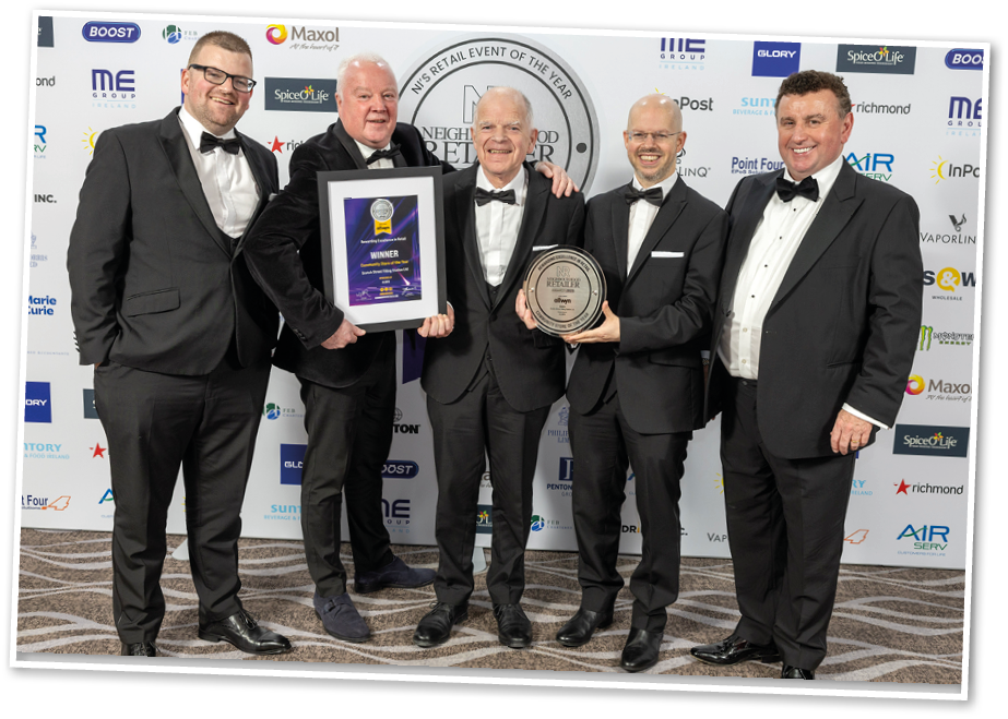 Four men wearing suits and ties are standing together. Description generated by AI