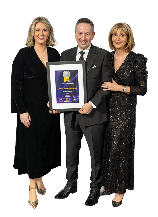 Three people are standing in front of a framed award. Description generated by AI