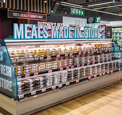 A display of food in a store. Description generated by AI