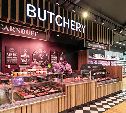 A butcher shop with a wooden counter and a sign that says “butcherery". Description generated by AI
