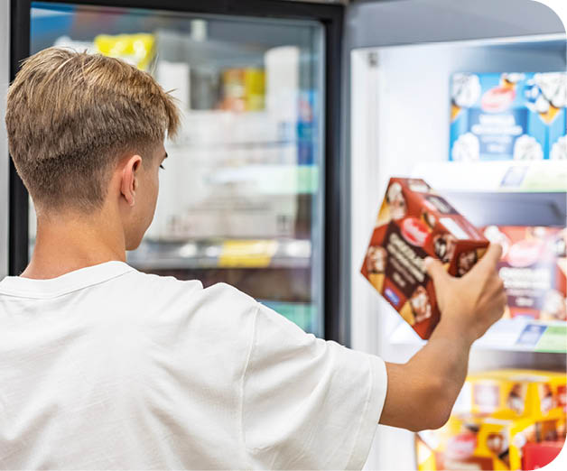 A man is holding a box of cookies. Description generated by AI