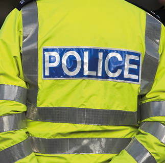 A yellow jacket with the word police on it. Description generated by AI