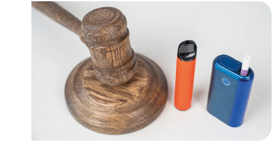 A blue and orange object is next to a wooden gavel. Description generated by AI