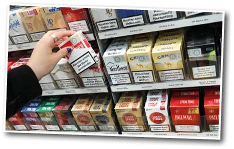A person holding a pack of cigarettes. Description generated by AI