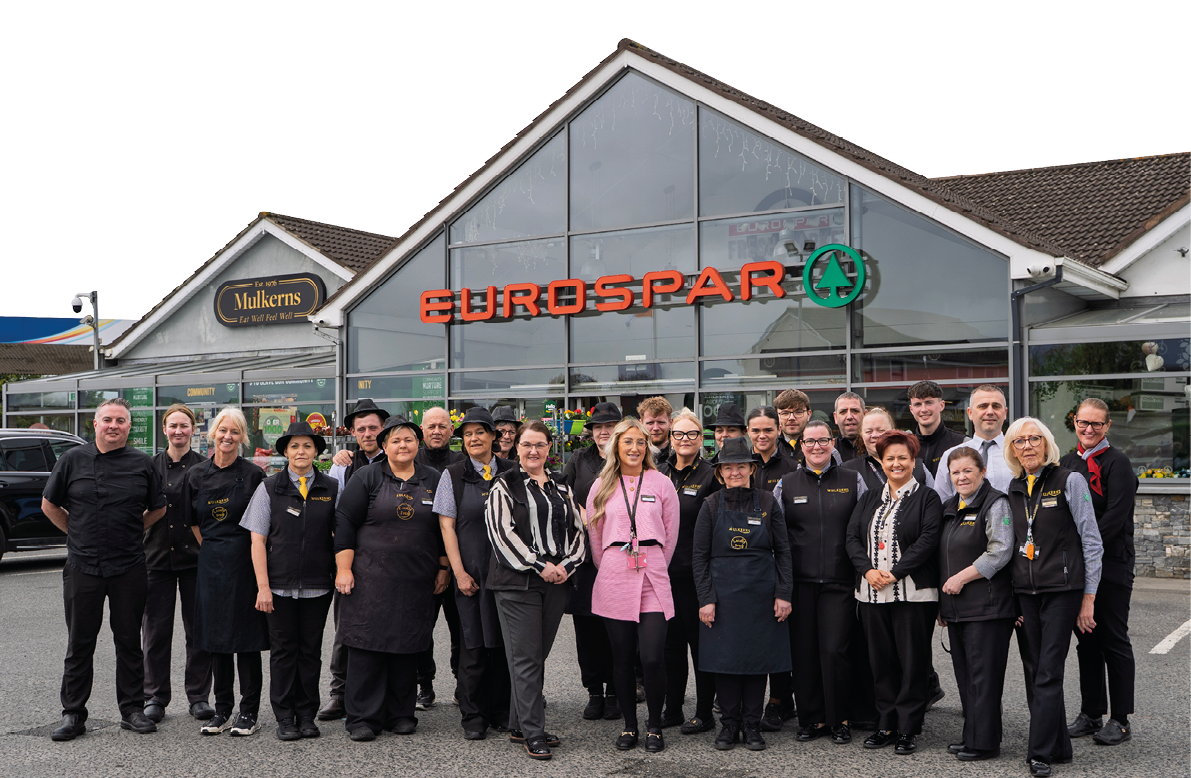A group of people standing in front of a restaurant. Description generated by AI
