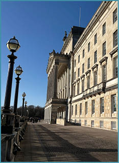 A large building with a clock tower and a flag. Description generated by AI
