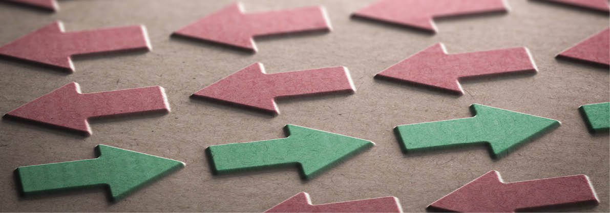 3D illustration of red arrows pointing the left side of the image and green ones in the opposite direction. Going against the grain concept