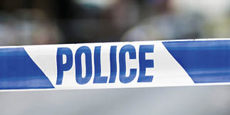 Police tape at the cordon of a crime scene.