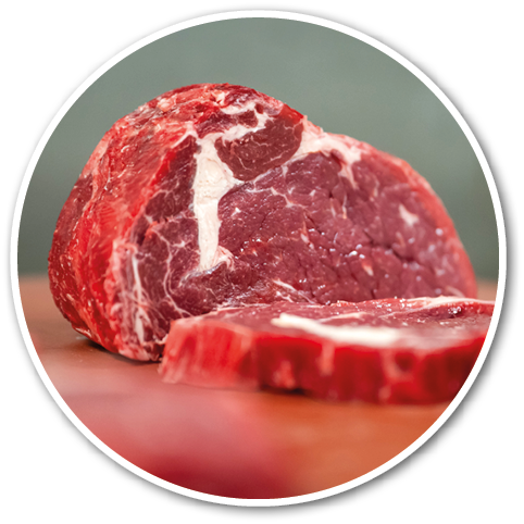 A close-up of a raw cut of marbled red meat resting on a surface with a blurred background. Description generated by AI