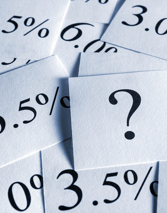 A collection of white paper squares with various percentage numbers printed in black surrounds a central square featuring a large black question mark. Description generated by AI