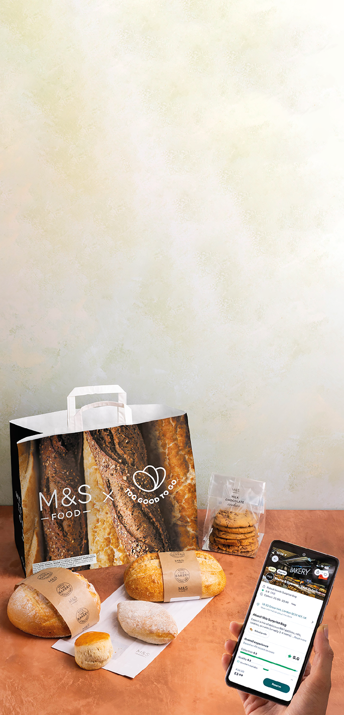 A person wearing a white shirt is holding a white shopping bag against a plain light-colored background. Description generated by AI