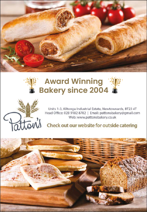 Three sausage rolls and sliced cherry tomatoes on a wooden board above an advertisement for Patton's award-winning bakery with various breads and flatbreads displayed below. Description generated by AI