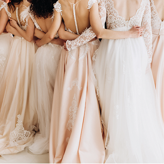 close-up of a girl in wedding dresses are standing with her back and arms hugging her waist