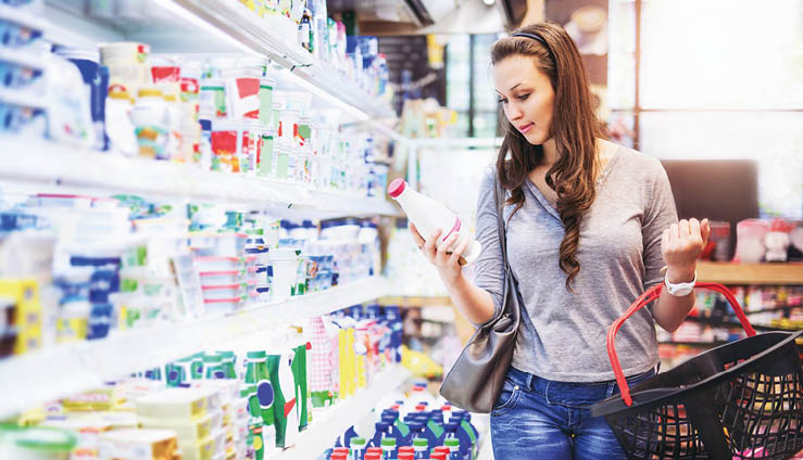 Female buying milk in supermarket