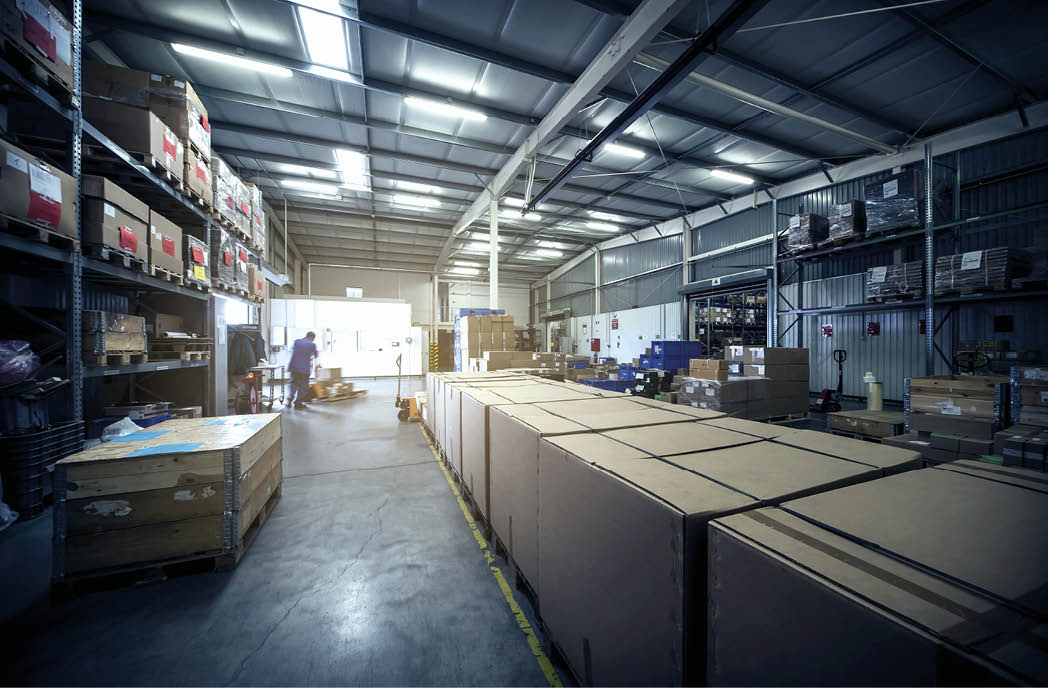 warehouse interior with paper boxes and worker with forklift in blue vintage color tone