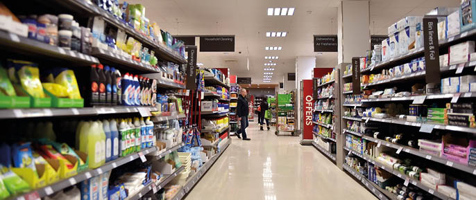 Bath, UK - February 10, 2016: People shop in an aisle in a Waitrose supermarket. Founded in 1904 Waitrose is the food retail division of the John Lewis, Britain's largest employee owned retailer.