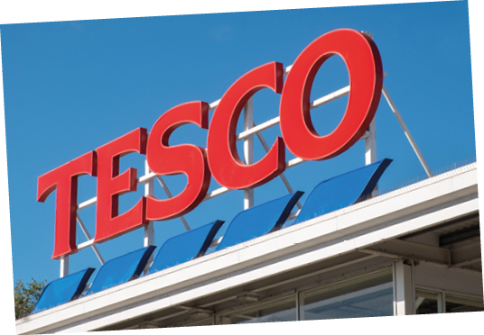 Evesham, UK - October 2017: Tesco supermarket sign atop a store exterior