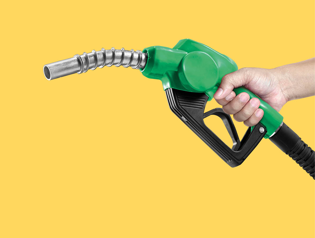 Hands holding Fuel nozzle on yellow background