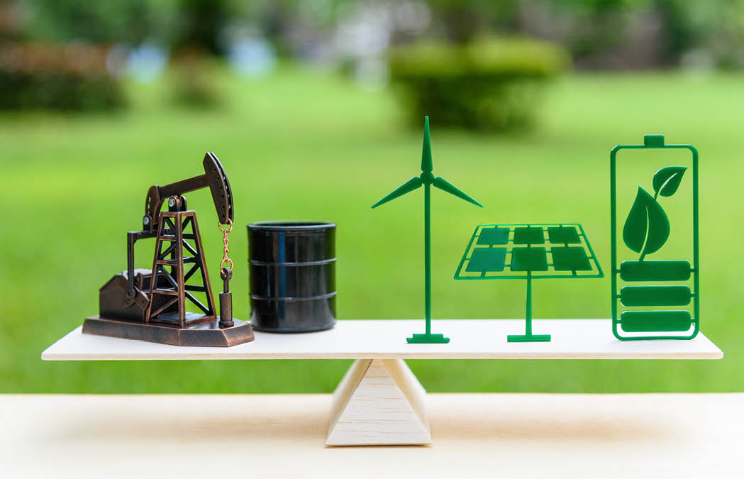 Fossil fuel vs renewable / future clean alternative energy concept : Petroleum pumpjack, crude oil drum barrel, solar panel, green leaf battery, wind turbine on a wood balance scale in equal position.