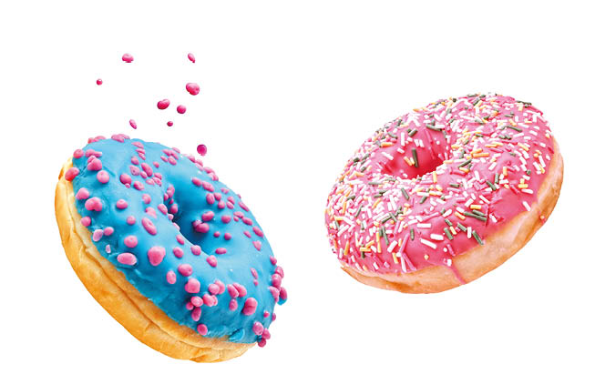 Fresh sweet donuts in motion with multicolored fruit glaze and sprinkles decorated. Fast sweet food concept, bakery ad design elements with glazed frosted falling doughnuts isolated, white background