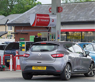 Clitheroe, Lancashire/UK - June 18th 2019: Texaco petrol station with Spar shop and cars at petrol pumps on forecourt