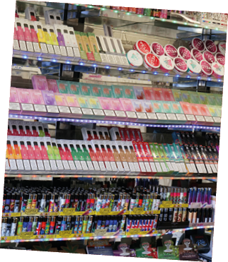 London, UK 08 28 2024 Rows of vibrant disposable electronic cigarette vapes and lighters stacked on shelves in a tourist shop in the city