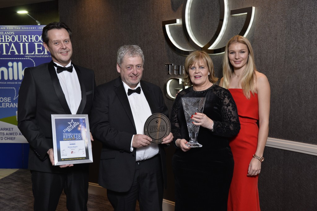 Milestone Nisaextra owner Tom McAvoy accepting the Neighbourhood Retailer of the Year award with David Atkinson (far left), retail development coach from category sponsor Imperial Tobacco, Tom’s wife Ann McAvoy, and model Ella Killen