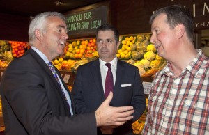 Minister Bell and Glyn Roberts speak with a local retailer