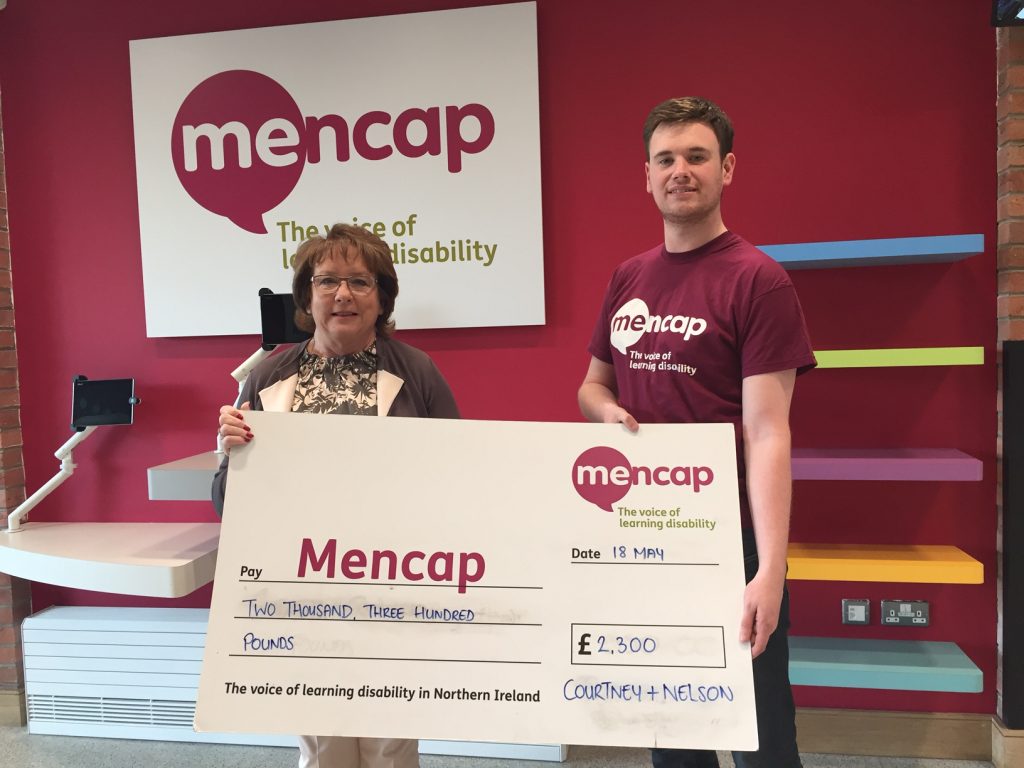 Courtney & Nelson director Pamela McWilliams handing over the cheque to a representative from Mencap