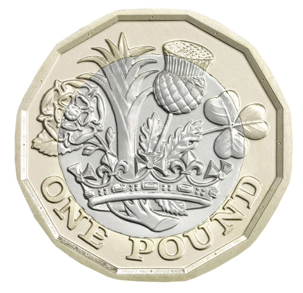 The reverse side of the coin, the ‘tails’, shows the English rose, the Welsh leek, the Scottish thistle and the Northern Irish shamrock emerging from one stem within a royal coronet