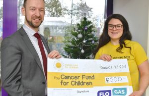 Paul Ruegg, senior marketing executive, Flogas NI, presents a £500 cheque to Sorcha MacLaimhin corporate fundraiser for Cancer Fund for Children at their offices in Belfast