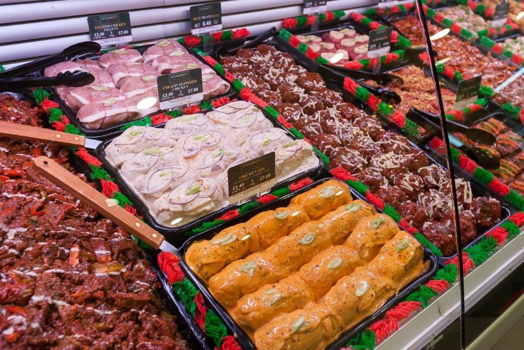 A counter filled with delicious meats and sauces